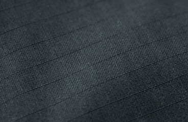 macro black ripstop, polyester or nylon fabric textured background closeup