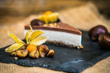 Light delicious yogurt cheesecake with physalis, nut and chestnuts  . Close up