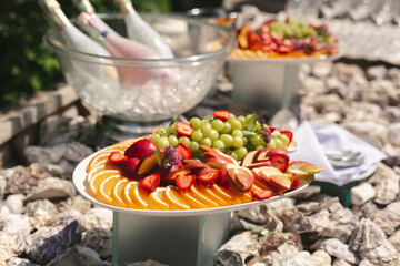 Beautiful wedding candy bar with a lot of sweets, fruits and food. Wedding banquet table