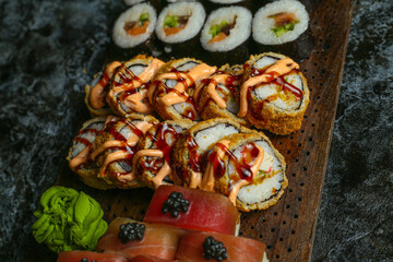 Traditional delicious fresh sushi roll set on a black background