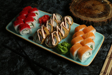 Traditional delicious fresh sushi roll set on a black background