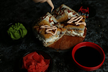 Traditional delicious fresh sushi roll set on a black background