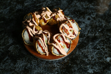 Hot fried Sushi Roll with salmon, avocado and cheese.