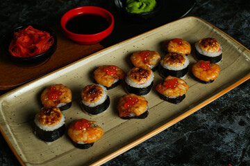 Traditional delicious fresh sushi roll set on a black background