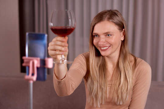 Online Date, Safe Meeting With Friends. Woman Talking By Video Chat To Her Boyfriend Using Smartphone And Drinking Red Wine. Social Distance. - Powered by Adobe