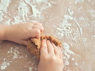 kid hands making cookie dough. Kneading dough. Cooking and baking. Background with place for text