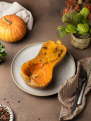 Baked pumpkin half on a plate with thyme