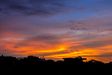 Dramatic sunrise sky with clouds. Dramatic sunrise over the village Bangkok.