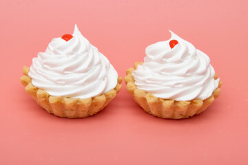 cakes are white with protein cream on a pink background