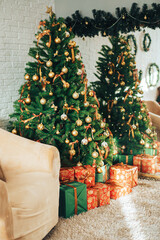 Decorated Christmas tree with gift gifts standing in against of the mirror