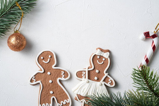 Decorated Christmas Gingerbread Cookies With Decorations On White Table Background.