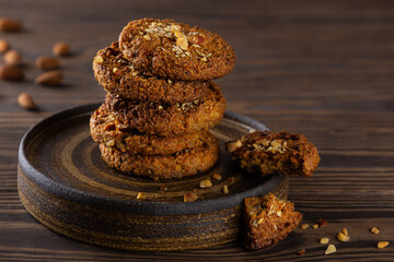 Stacked cereal cookies on a dark plate. Sugar, gluten, lactose free, vegan.