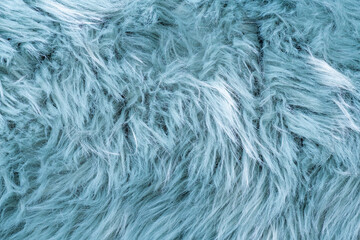 Trendy artificial fur texture. Fur pattern top view. Blue fur background. Texture of blue shaggy fur. Wool texture. Flaffy sheepskin close up