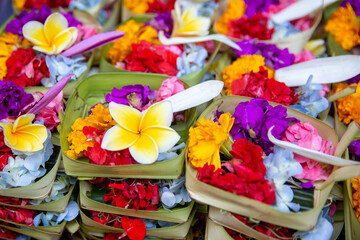 Traditional balinese offerings to gods in Bali with flowers.