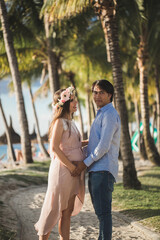 Fototapeta premium Beautiful pregnant girl and man on the beach