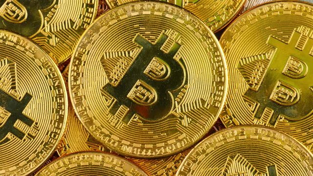 Crypto currency, bitcoin mining. Macro shot of rotating bitcoins