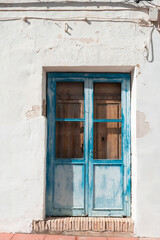 Fototapeta na wymiar Old blue door with cracked paint.