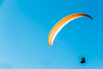 paraglider in the blue sky