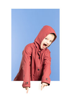 Little Girl Wearing A Red Raincoat And Pointing Down To Comment Section In Social Media. Girl Asking For Engagement On Social Network.