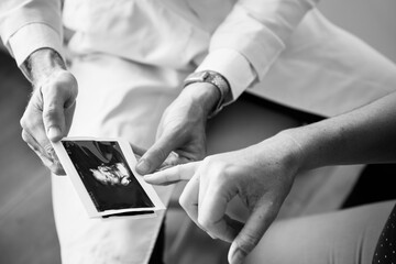 Pregnant woman having fetal monitoring by doctor