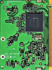 Detail of a green computer component with circuits for connections and memory