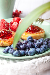 Cottage cheese pancakes with raspberry jam, blueberries and strawberries