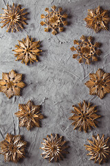 New Year's straw toys, on a gray concrete background. Christmas card