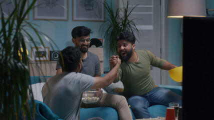 Indian fans giving high five and celebrating goal