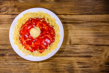 Christmas salad in shape of Santa Claus hat on a wooden table. Christmas and New year concept. Top view