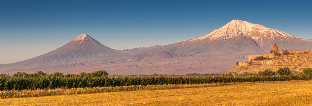 Panoramic view of one of the main attractions of Armenia - the monastery of Khor Virap and the famous Mount Ararat bathed in light at dawn.