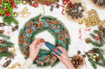 Making a large Christmas wreath step by step, step 10 - glue chestnuts with hot glue