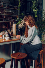 Business woman with curly hair working at the remote office