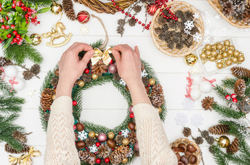 Making a large Christmas wreath step by step, step 19 - glue a small bow on the wreath