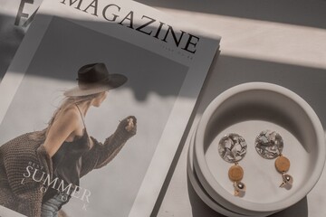 Fashion magazine and earrings, aesthetic photo