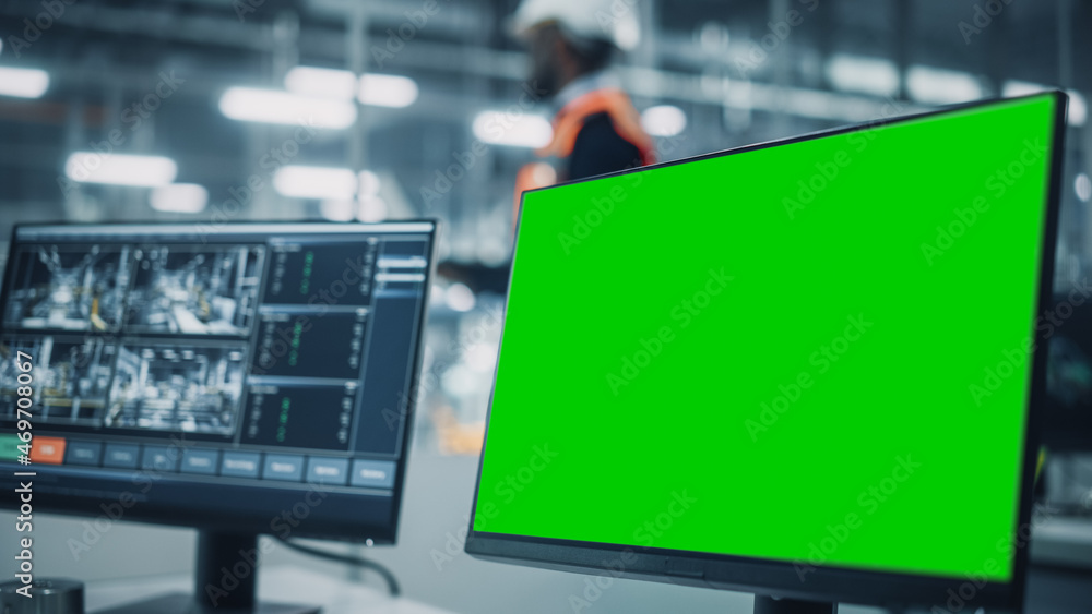 Leinwandbilder Vehicle Factory Line Operator Working at Desk with Computer with Green Screen Template Display Great for Mock Up. Office at a Car Assembly Plant
