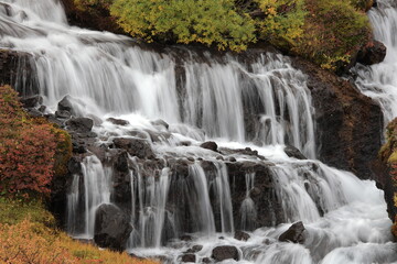 Fototapeta na wymiar Hraunfossar, a cascade of small waterfalls flowing into the Hvita river, Vesturland, Iceland.