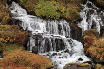 Hraunfossar, a cascade of small waterfalls flowing into the Hvita river, Vesturland, Iceland.