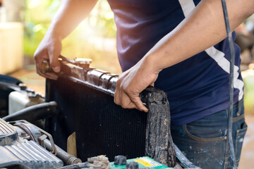 Car radiator,The car technicians is changing the new radiator in the car.