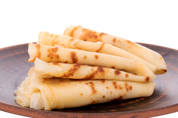 Several fragrant homemade pancakes on a ceramic plate, close-up, isolated on white.