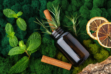 Set of brown glass bottles beauty products on moss background