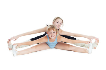 Two sisters gymnasts work together to perform gymnastic exercise. Isolated on white background. - obrazy, fototapety, plakaty