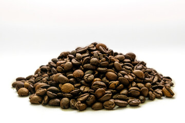 Handful of roasted coffee beans on white background