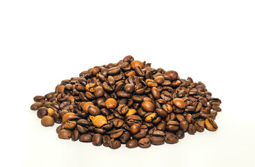 Handful of roasted coffee beans on white background