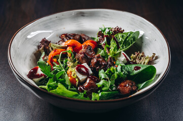 Warm salad with grilled chicken liver. Restaurant menu, dieting, cookbook recipe.