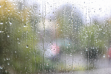 Window glass with water drops, closeup. Rainy weather