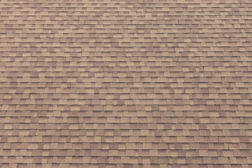 brown roof shingles background and texture. dark asphalt tiles on the roof.