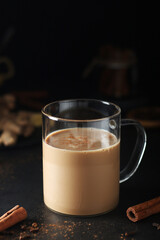 A cup with masala chai in low key	