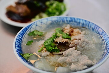 Big pieces of pork in thick soup with rice vermicelli.
