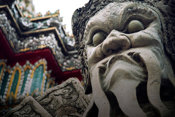 A large Chinese cement giant guards the gates of Wat Pho in Thailand.