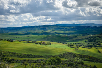 Fototapeta na wymiar Tuscany, italy, may 2018, panoramic view of a green valley with a lake and olive trees